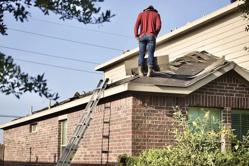 Professional roofer working on a residential roof in Brantly